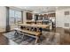 Spacious dining area connected to kitchen featuring stylish rug, large table and bench and modern lighting at 16201 Lanceleaf Pl, Parker, CO 80134