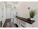 Inviting entryway featuring dark wood floors, a console table, and white walls, creating a bright and welcoming space at 16201 Lanceleaf Pl, Parker, CO 80134