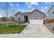 Charming single-Gathering home featuring a two-car garage and stone accents on the facade and well-maintained lawn at 16201 Lanceleaf Pl, Parker, CO 80134
