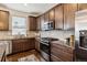 Well-equipped kitchen with stainless steel appliances, dark cabinets, granite countertops, and tile backsplash at 16201 Lanceleaf Pl, Parker, CO 80134