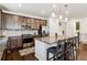 Modern kitchen with stainless steel appliances, granite countertops, and dark wood cabinetry with seating at the island at 16201 Lanceleaf Pl, Parker, CO 80134