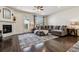 Cozy living room with hardwood floors, a fireplace, a comfortable sectional sofa, and a view of the backyard at 16201 Lanceleaf Pl, Parker, CO 80134
