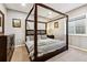 Inviting primary bedroom featuring a four-poster bed, soothing colors, and tasteful decor at 16201 Lanceleaf Pl, Parker, CO 80134