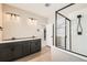 Bathroom features a double sink vanity and walk-in shower with glass door at 4104 Grand Lake St, Brighton, CO 80601