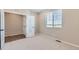 Cozy bedroom with neutral walls, carpet floors, and a large window at 4104 Grand Lake St, Brighton, CO 80601
