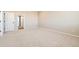 A bright bedroom with carpeted floor and a closet that leads to the bathroom at 4104 Grand Lake St, Brighton, CO 80601