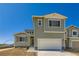 Two-story home featuring a two-car garage and modern architectural details at 4104 Grand Lake St, Brighton, CO 80601