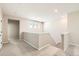 Upstairs hallway featuring neutral walls and natural light from window at 4104 Grand Lake St, Brighton, CO 80601