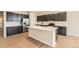 Spacious kitchen with stainless steel appliances, a large island, and dark wood cabinets at 4104 Grand Lake St, Brighton, CO 80601