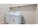 The laundry room includes new washer, dryer, and shelving for storage at 4104 Grand Lake St, Brighton, CO 80601