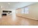 Bright living room with hardwood floors and ample natural light from large windows at 4104 Grand Lake St, Brighton, CO 80601
