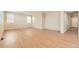Bright living room with hardwood floors and ample natural light from large windows at 4104 Grand Lake St, Brighton, CO 80601