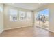 Bright living room with hardwood floors and ample natural light from large windows at 4104 Grand Lake St, Brighton, CO 80601