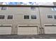 Rear exterior view showcasing attached garages at 4134 S Fraser Way # E, Aurora, CO 80014
