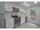 Modern kitchen features white cabinets, stainless steel appliances, and backsplash at 4134 S Fraser Way # E, Aurora, CO 80014