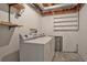 Basement laundry room with washer, dryer, and shelving at 4134 S Fraser Way # E, Aurora, CO 80014