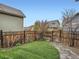 Green backyard with a stone path and view of neighboring houses at 5535 W 96Th Pl, Westminster, CO 80020