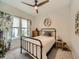 Cozy bedroom with a ceiling fan, a window with curtains, carpet, and a metal frame bed at 5535 W 96Th Pl, Westminster, CO 80020