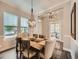 Elegant dining room featuring a modern chandelier, hardwood floors, and large windows, perfect for Gathering gatherings at 5535 W 96Th Pl, Westminster, CO 80020