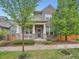Charming two-story brick home with a covered front porch, well-maintained landscaping, and mature trees in a suburban neighborhood at 5535 W 96Th Pl, Westminster, CO 80020