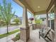 Covered front porch featuring brick columns, hanging flower baskets and comfortable seating, offering a relaxing outdoor space at 5535 W 96Th Pl, Westminster, CO 80020