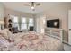 This main bedroom has a TV and dresser with decorative details at 5535 W 96Th Pl, Westminster, CO 80020