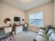 Well-lit home office with built-in desk, plush carpet, and a comfortable couch for breaks at 5535 W 96Th Pl, Westminster, CO 80020