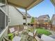 Inviting covered patio with stylish furniture and a view of the landscaped backyard at 5535 W 96Th Pl, Westminster, CO 80020