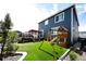 Backyard with a wooden playset, artificial turf, and a well-maintained lawn at 3722 Sandy Vista Trl, Castle Rock, CO 80104