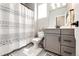 Well-lit bathroom with a modern vanity, decorative shower curtain, and contemporary fixtures at 3722 Sandy Vista Trl, Castle Rock, CO 80104