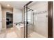 Stylish bathroom featuring a walk-in shower, soaking tub, and tile flooring at 3722 Sandy Vista Trl, Castle Rock, CO 80104