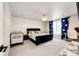 Spacious bedroom with a stylish black bed, crib, and a bright window with blue curtains at 3722 Sandy Vista Trl, Castle Rock, CO 80104