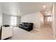 Relaxing bonus room featuring a comfortable leather sofa and a bright, airy atmosphere at 3722 Sandy Vista Trl, Castle Rock, CO 80104
