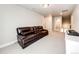 Cozy bonus room featuring a comfortable sofa, carpeted floors, and ample space for a home theater at 3722 Sandy Vista Trl, Castle Rock, CO 80104