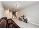 Cozy bonus room with a leather sofa, plush carpet, and stylish light fixture at 3722 Sandy Vista Trl, Castle Rock, CO 80104