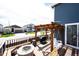 Wooden deck featuring a firepit, bench seating and an overhead pergola with lighting at 3722 Sandy Vista Trl, Castle Rock, CO 80104