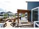 Wooden deck featuring a firepit, bench seating and an overhead pergola with lighting at 3722 Sandy Vista Trl, Castle Rock, CO 80104