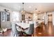Open concept living space with kitchen island, dining table, and lots of natural light at 3722 Sandy Vista Trl, Castle Rock, CO 80104