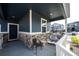 Inviting front porch featuring stylish seating, stone accents, and a welcoming entrance at 3722 Sandy Vista Trl, Castle Rock, CO 80104