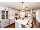 Bright kitchen features gray cabinets, an island with white countertops, and modern pendant lighting at 3722 Sandy Vista Trl, Castle Rock, CO 80104