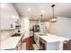 Modern kitchen features stainless steel appliances, center island, and quartz countertops at 3722 Sandy Vista Trl, Castle Rock, CO 80104