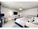 Bright main bedroom featuring a large bed, desk, and access to a walk-in closet at 3722 Sandy Vista Trl, Castle Rock, CO 80104