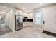 Bright kitchen featuring stainless steel appliances, white cabinets, and wood-look flooring at 9742 Taylor River Cir, Littleton, CO 80125