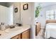 Bathroom view leading into a bedroom with a wooden dresser, providing a comforting and stylish transition at 8199 Welby Rd # 3102, Denver, CO 80229