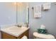 Cozy half bathroom with light blue walls and simple vanity at 8199 Welby Rd # 3102, Denver, CO 80229