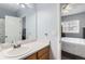 Upstairs bathroom features a single sink vanity and an open door to the bedroom at 8199 Welby Rd # 3102, Denver, CO 80229