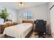 Bedroom features a ceiling fan, and desk with a large window at 8199 Welby Rd # 3102, Denver, CO 80229