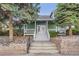Exterior of a clubhouse featuring a welcoming porch, landscaping, and double glass doors at 8199 Welby Rd # 3102, Denver, CO 80229
