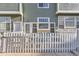 Charming townhome exterior with a white picket fence and inviting facade, perfect for Gathering living at 8199 Welby Rd # 3102, Denver, CO 80229