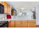 Kitchen features light wood cabinets and open view of the dining area at 8199 Welby Rd # 3102, Denver, CO 80229
